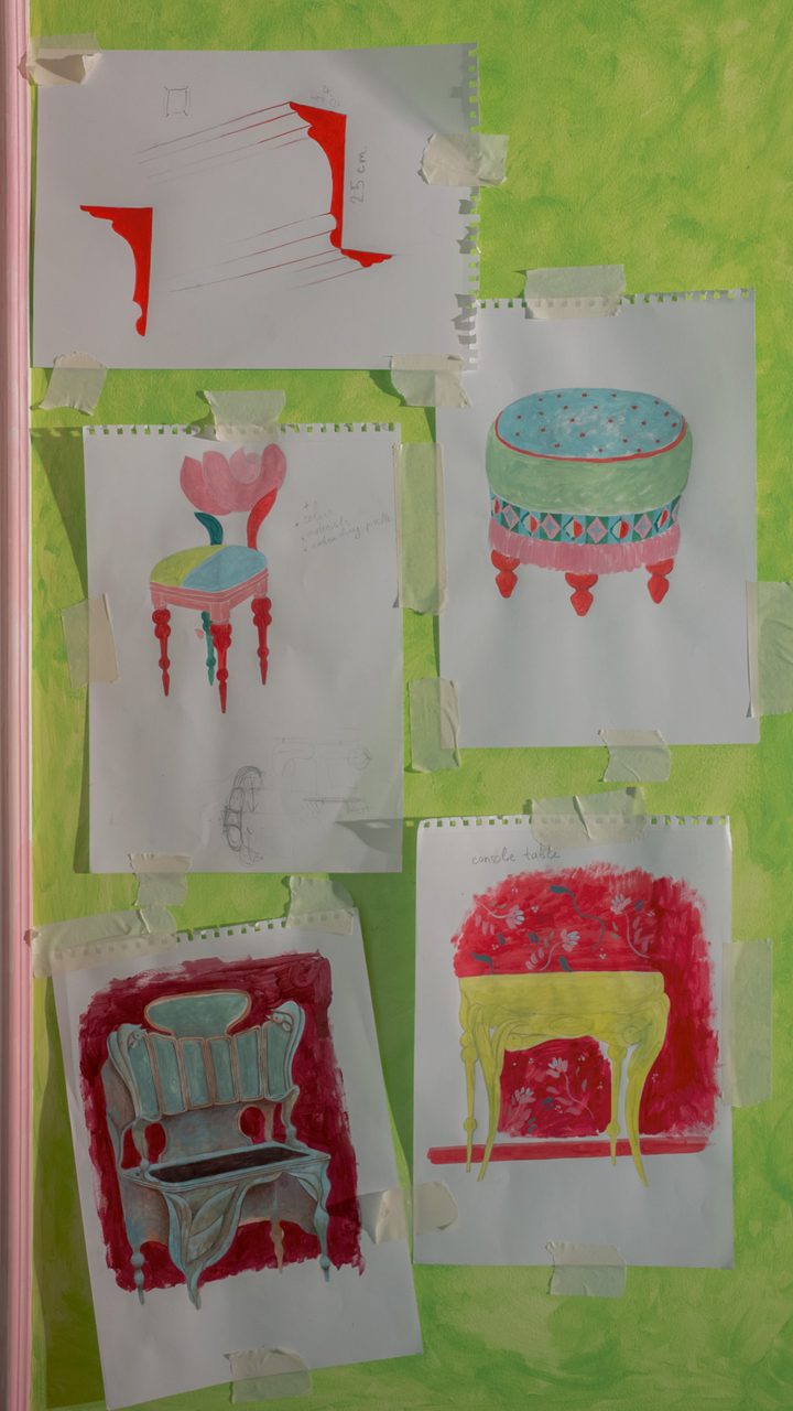 Furniture studies in gouache taped to a painted green wall