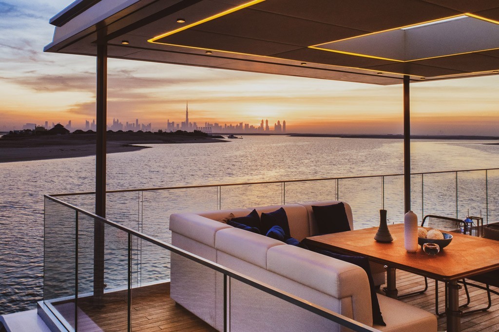 Outdoor lounge with sunset views at Floating Villa Dubai, Heart of Europe