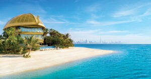 Golden dome beachfront villa surrounded by tropical gardens, overlooking Dubai skyline at The Heart of Europe.
