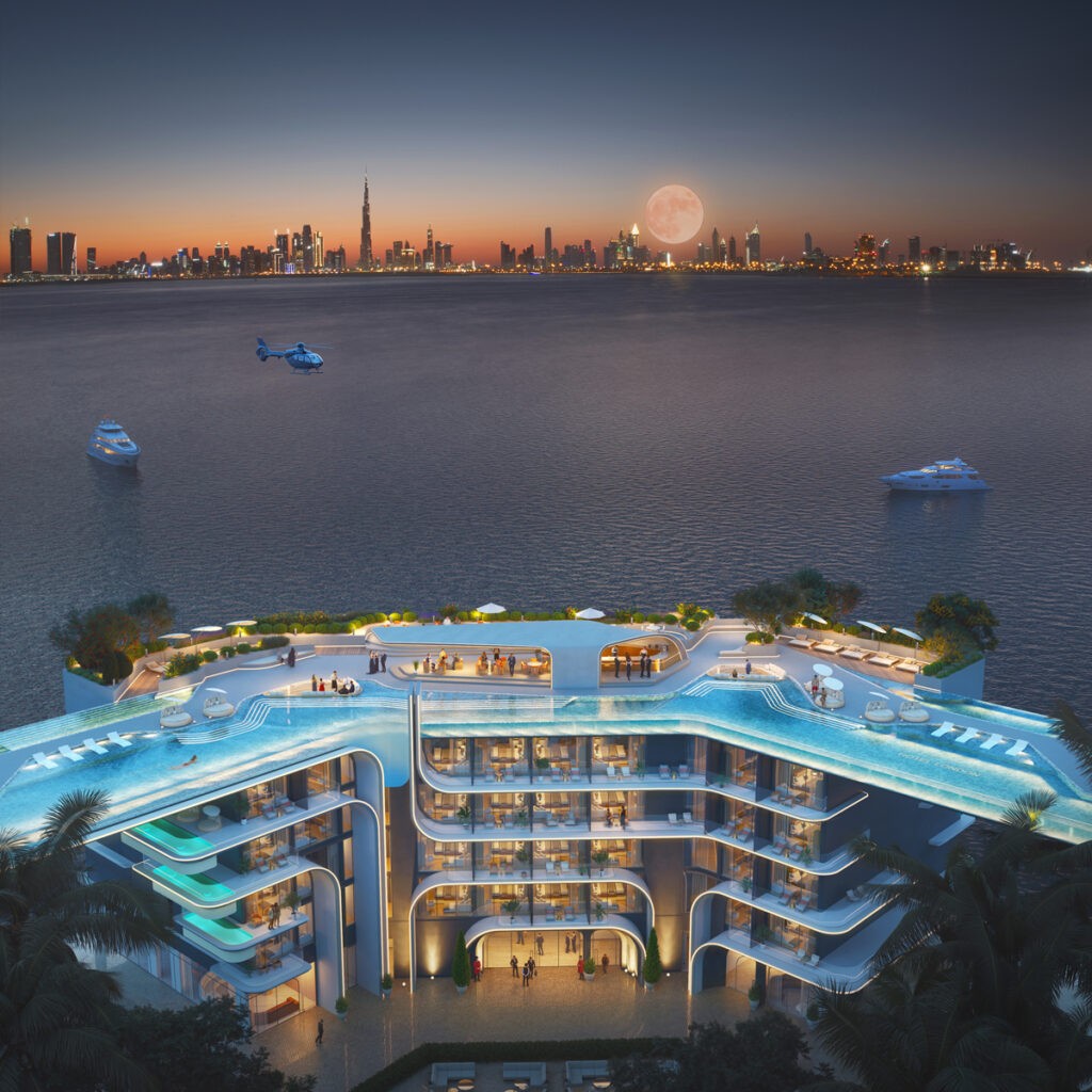 Night view of luxury island resort with rooftop infinity pool at The Heart of Europe Dubai, overlooking Arabian Gulf and illuminated city skyline.
